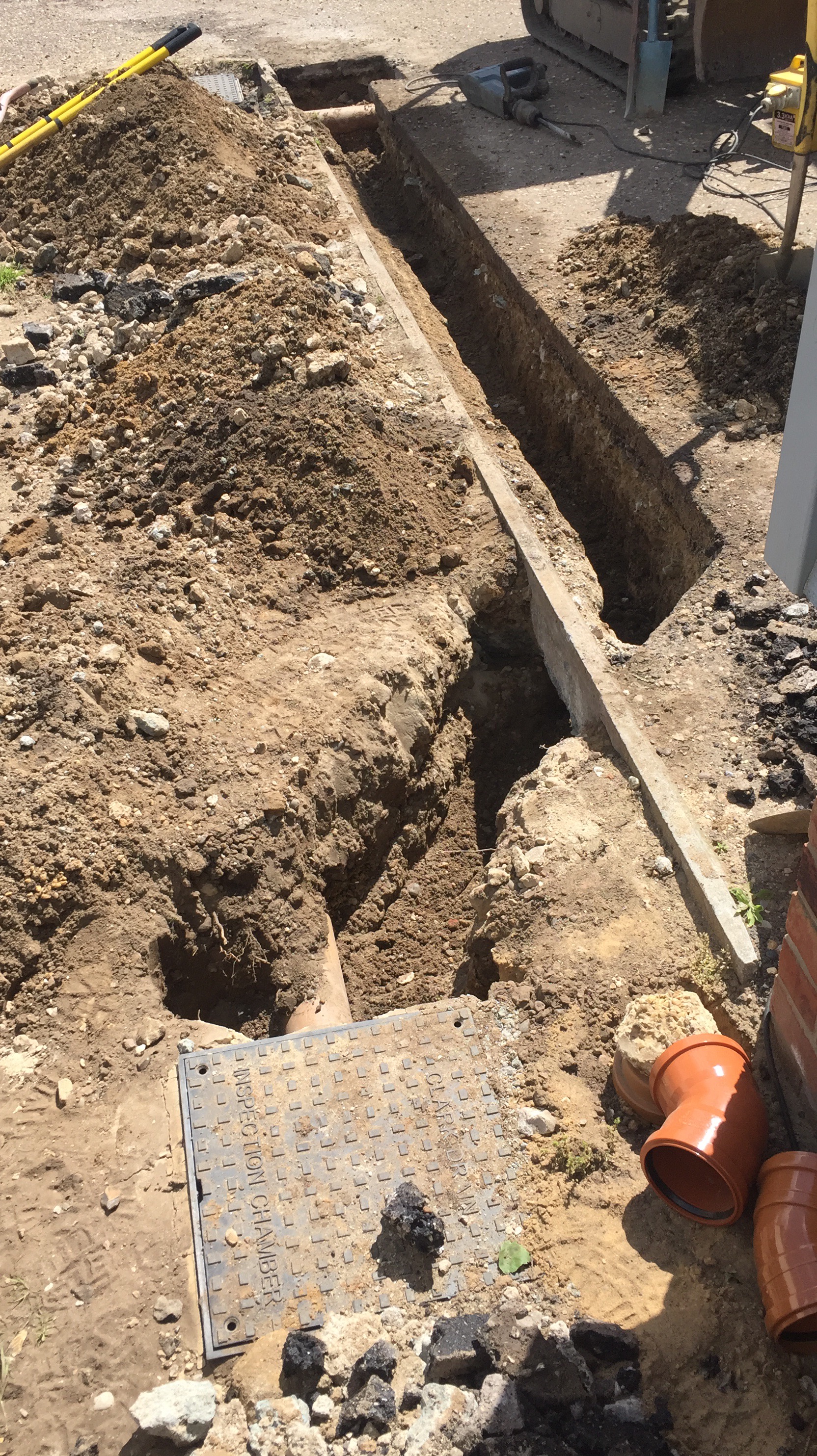 Shallow drain moved to allow block paving drive to be installed