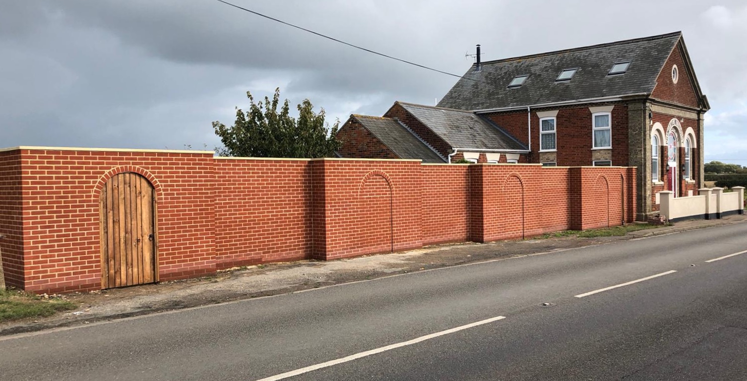 Large stepped Garden Walls with Arched Brickwork to reduce traffic noise
